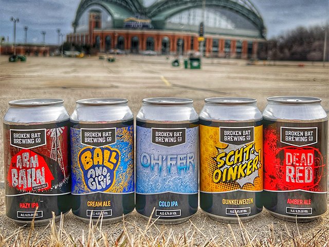 Five cans of different Broken Bat beers, with American Family Field looming in the background.