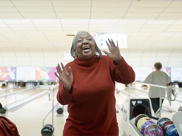 A still from the film 'Friday Night Blind' featuring a happy bowler.